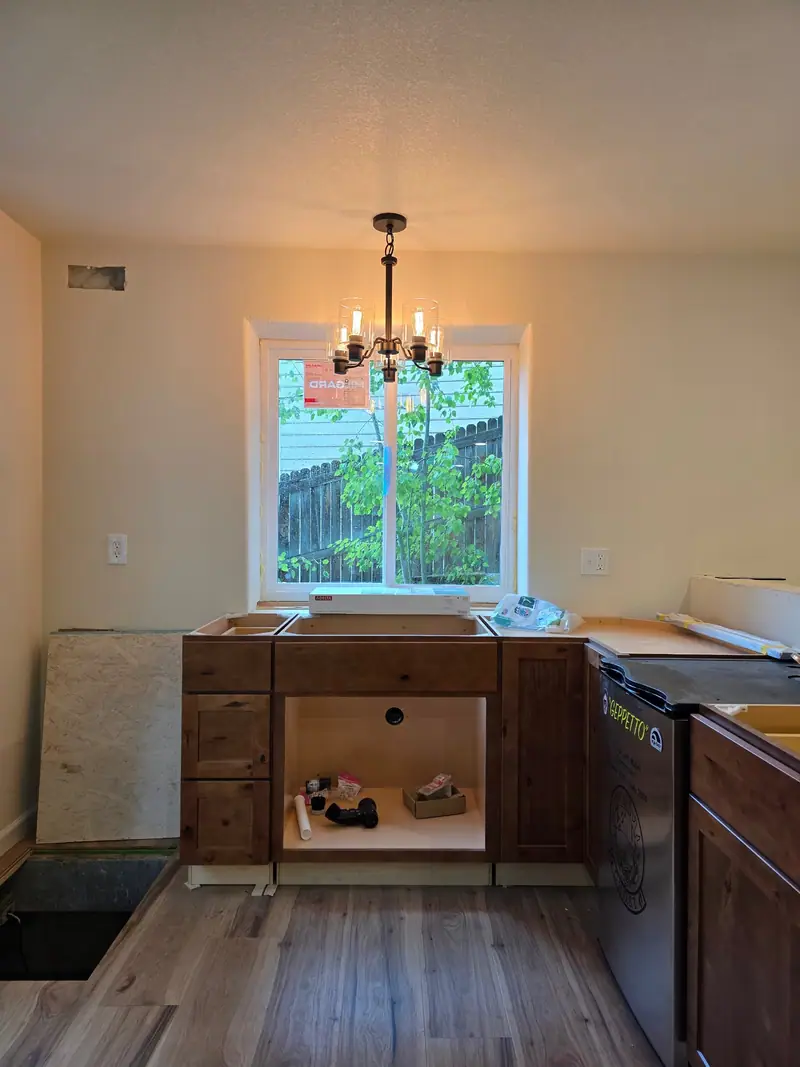 Basement bar nook mid-remodel with alder cabinet boxes set and no countertop yet