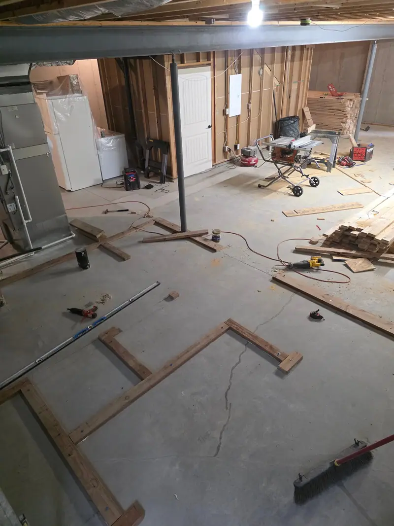 Basement wall layout with bottom plates on the concrete floor before framing