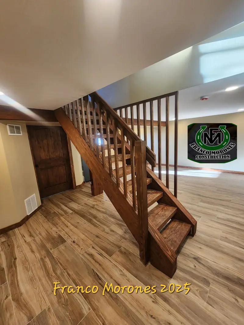 Custom stained wood basement staircase with balusters and wood-look plank floor