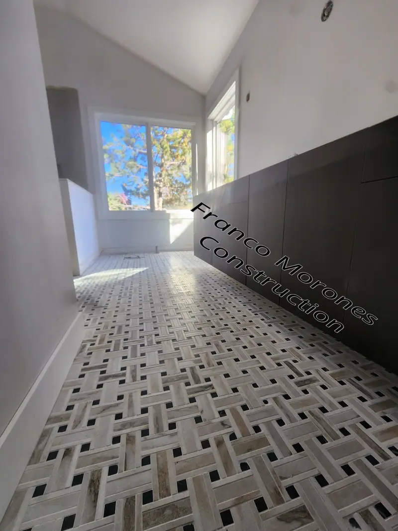 Basketweave marble mosaic floor tile laid down a long hallway